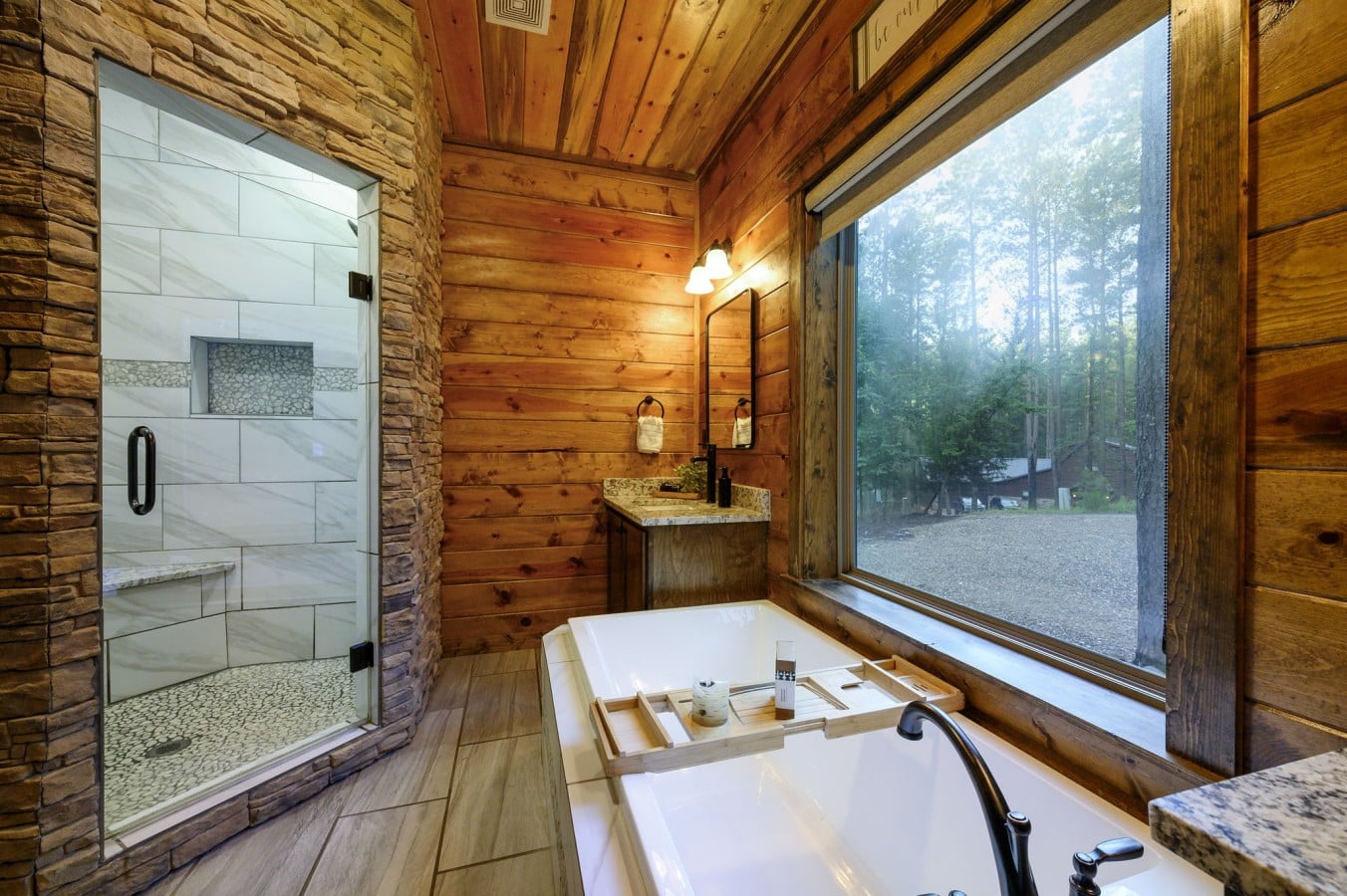Choose between a soaking tub or walk-in stone shower u2014 both with forest views included.