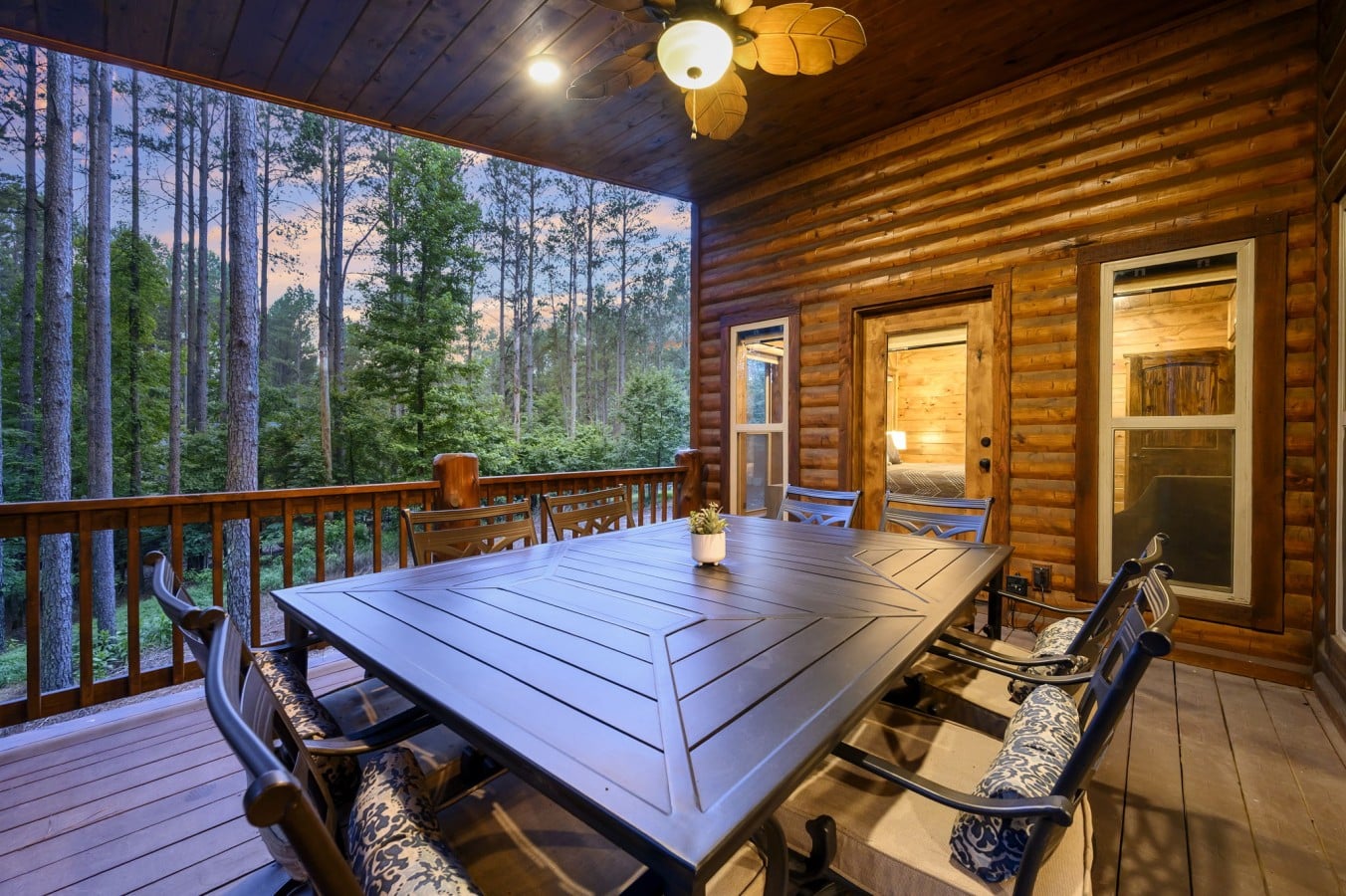 Warm bedroom light spills onto the deck, blending indoor comfort with outdoor evening bliss.