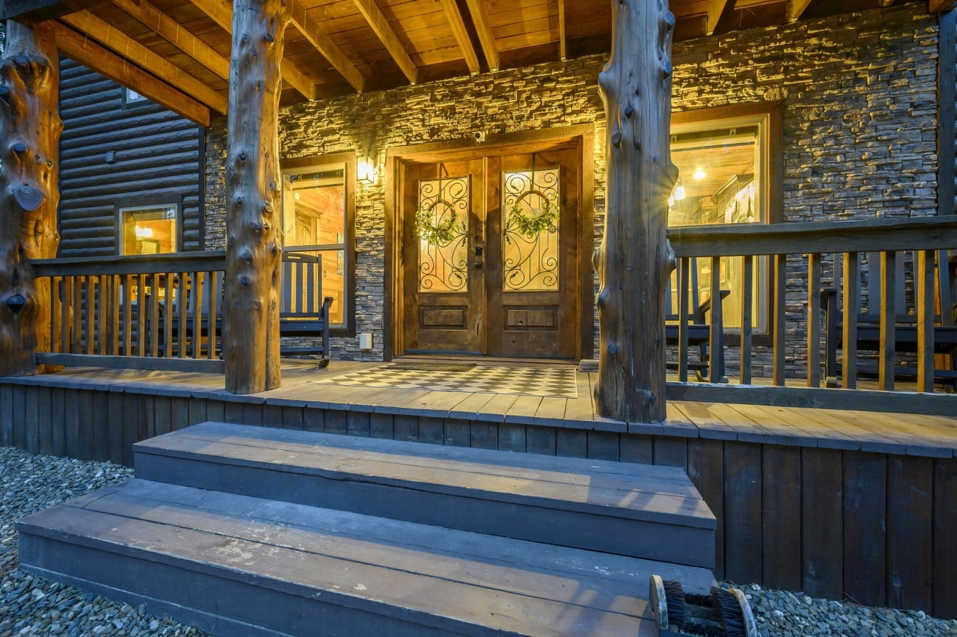 Grand double doors and a covered porch invite you into a truly luxurious mountain experience.