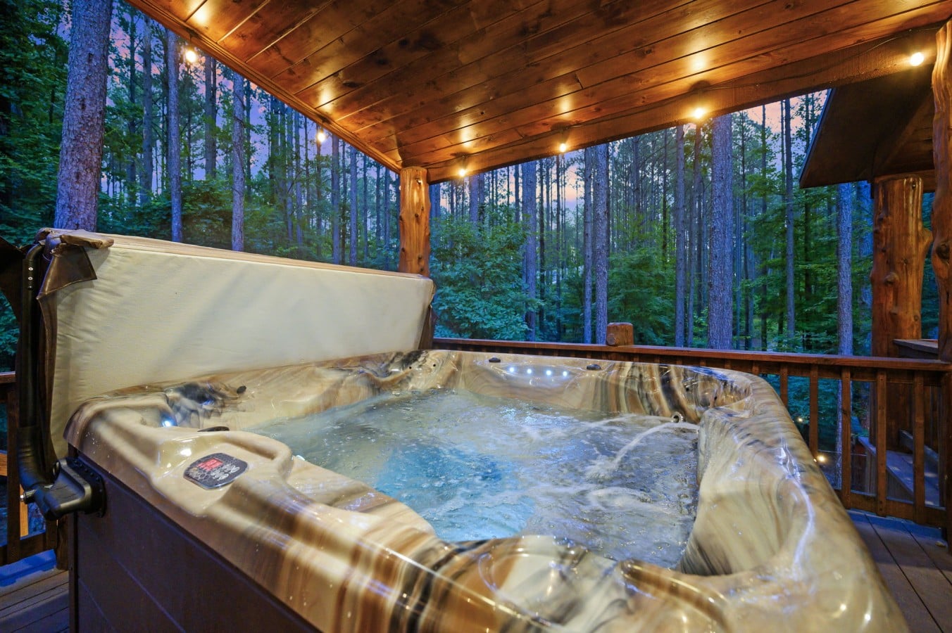 Blue LED jets, warm timber overhead, and an open forest u2014 hot tub relaxation at its finest.
