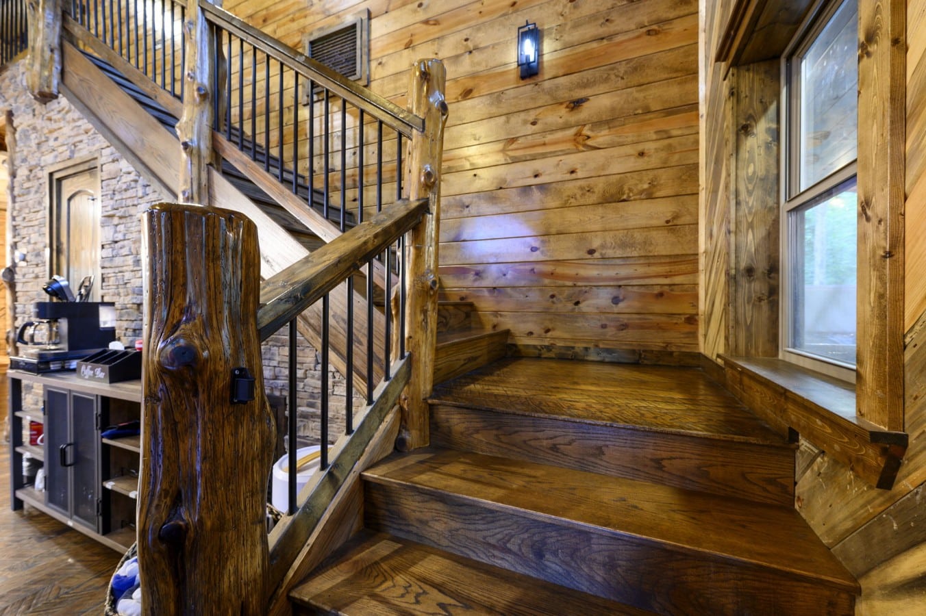 A handcrafted log staircase with a built-in coffee station fuels both mornings and adventures.