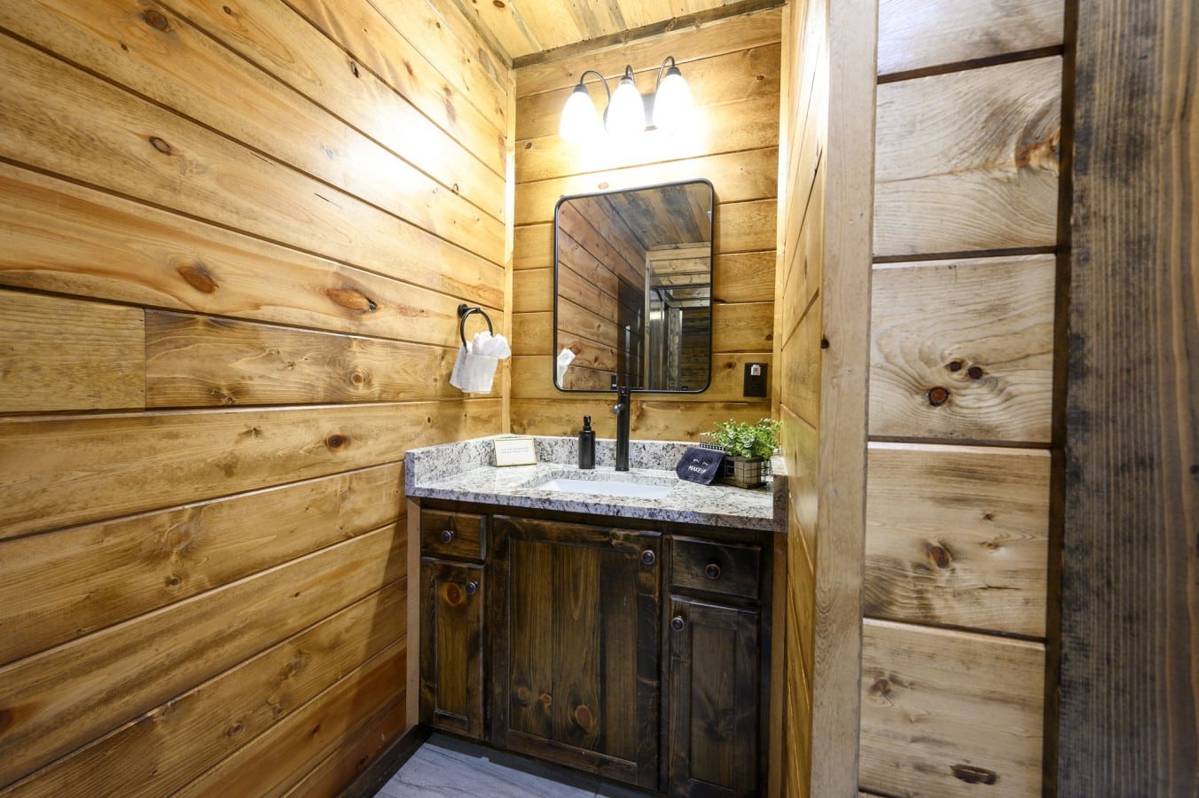 Warm vanity lighting and granite countertops make getting ready feel effortlessly luxurious.