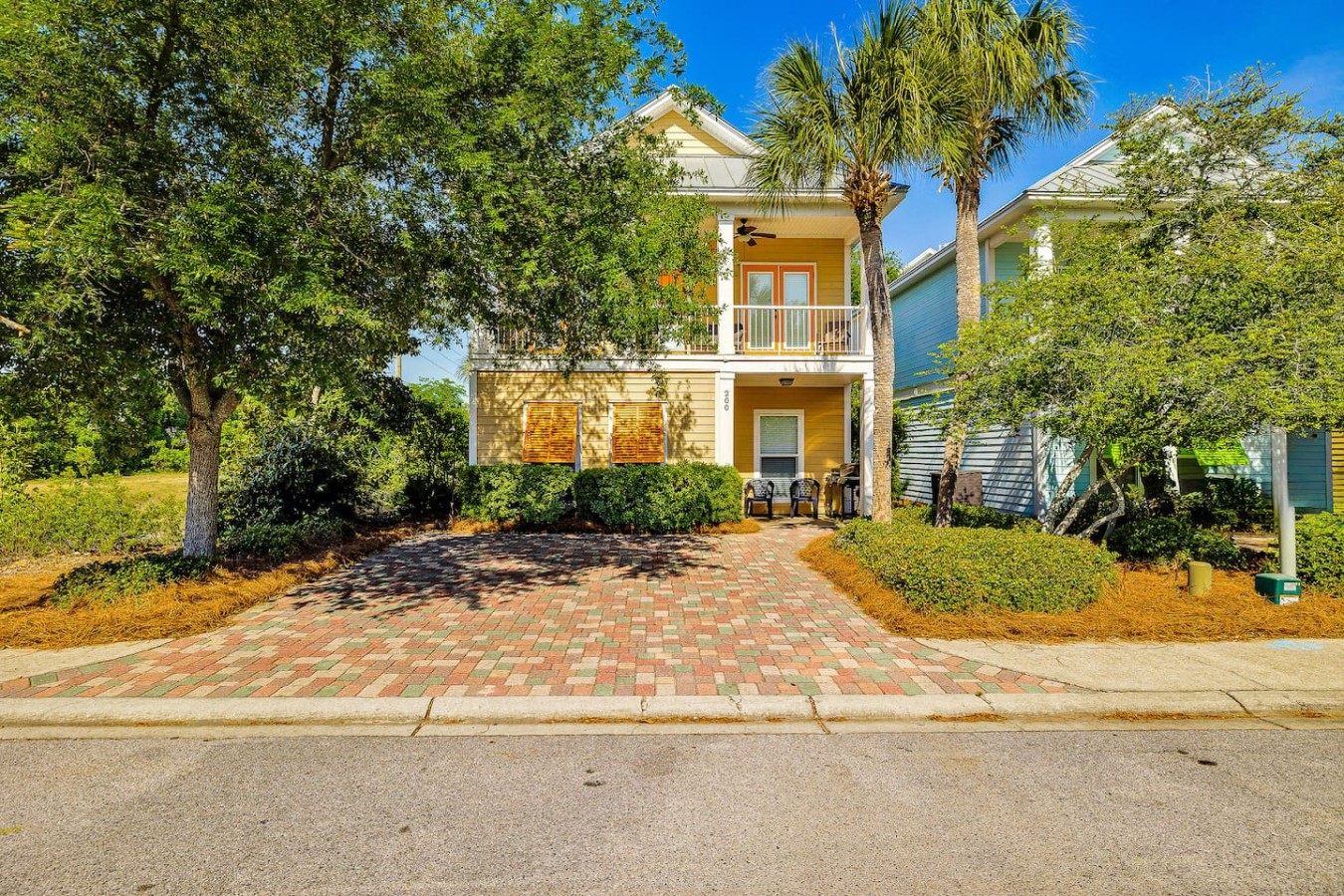 Lush tropical landscaping frames your picture-perfect coastal home away from home.