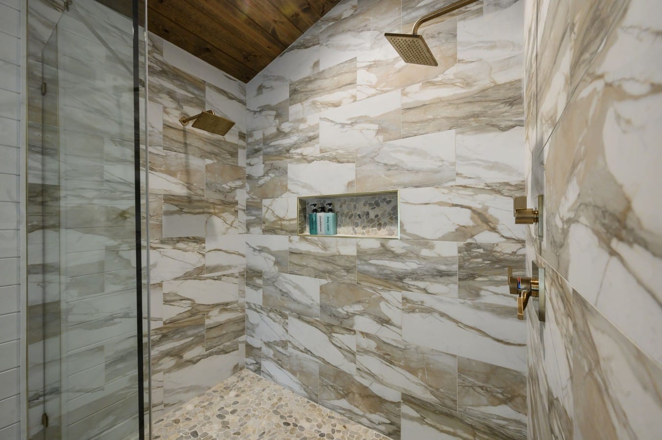 Dual rain shower heads and marble tile make every rinse feel like a spa retreat.
