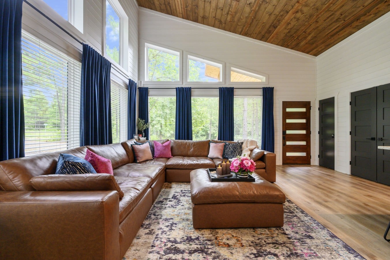Dramatic vaulted ceilings give the living room an airy, grand-lodge energy.