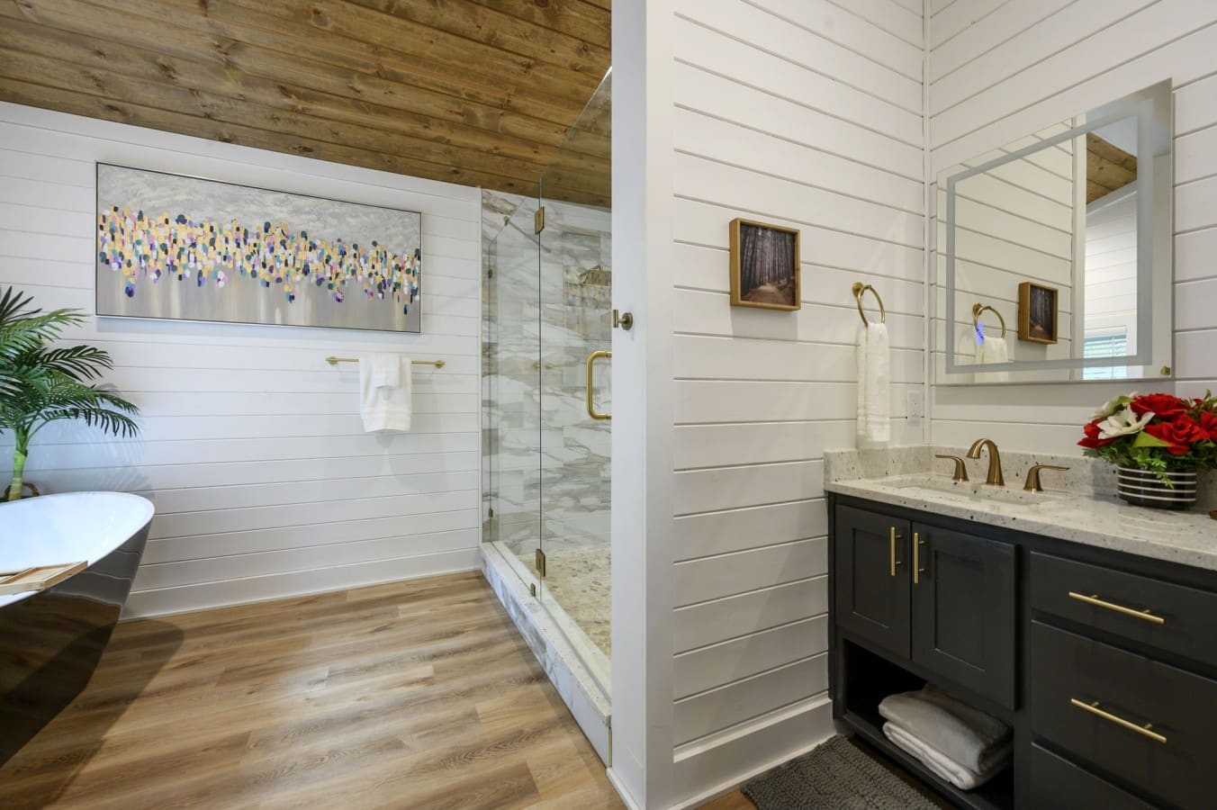 Indulge in dual sinks, a soaking tub, and a glass shower — all in one stunning room.