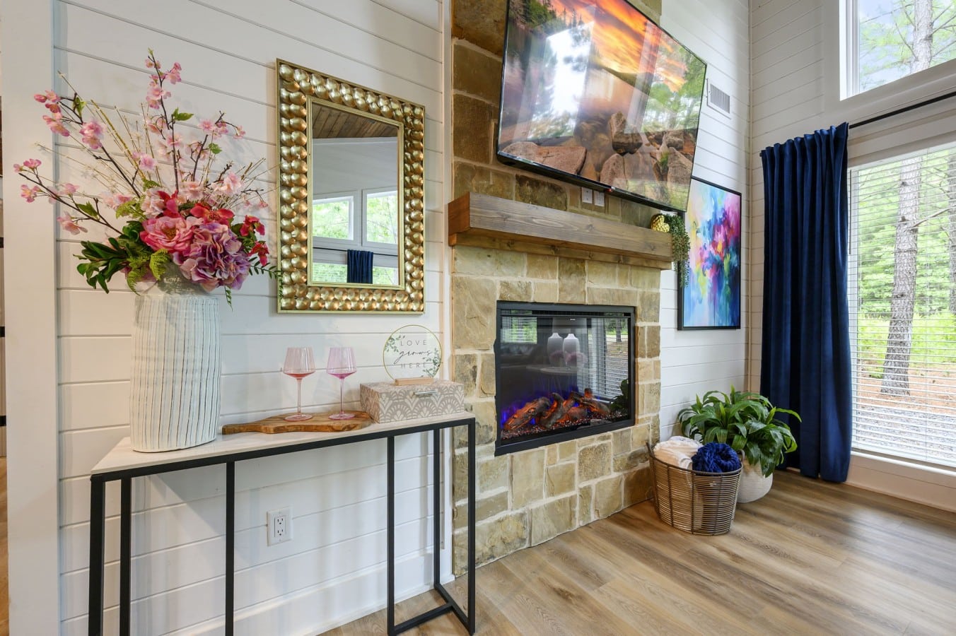 A stone fireplace, flowers, and wine glasses — romance is already set up for you.