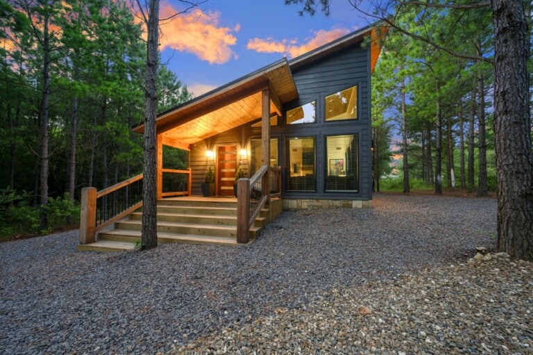 Your mountain escape glows at twilight, tucked among the pines.