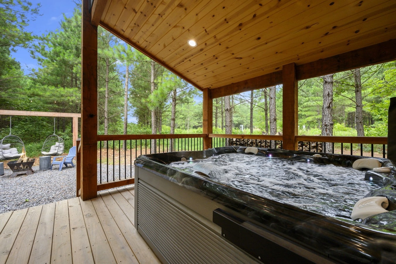Bubble away in the hot tub while egg chairs and a fire pit beckon below.