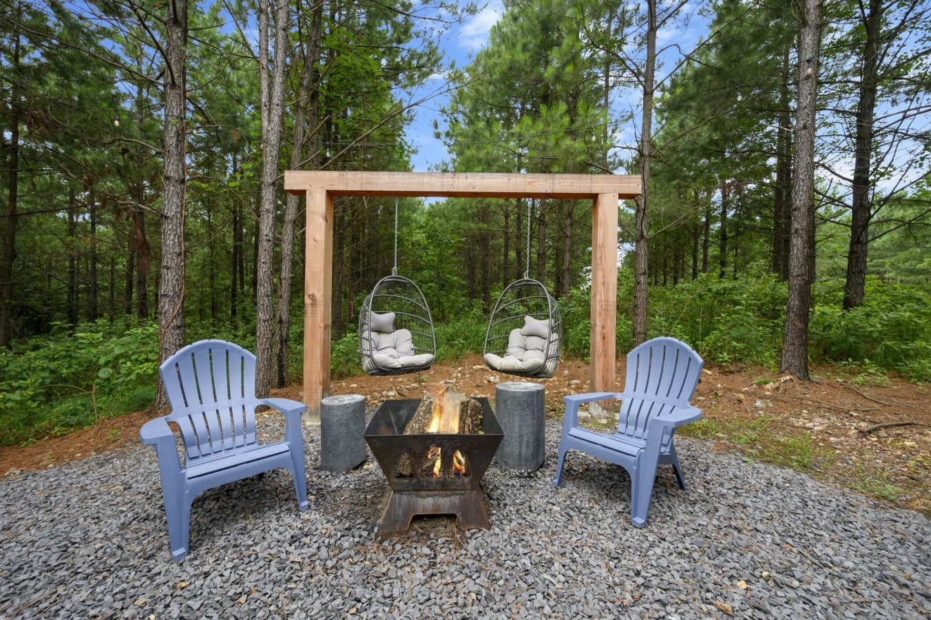 Gather around the fire pit in Adirondack chairs as the forest closes in around you.