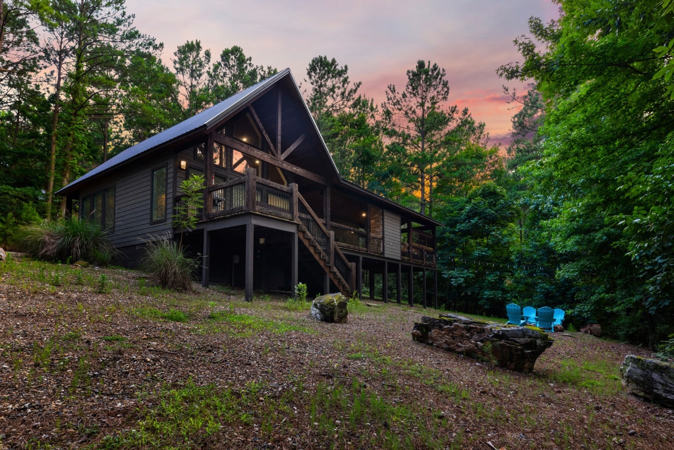 Rear exterior angle with deck, stairs, and fire pit area.