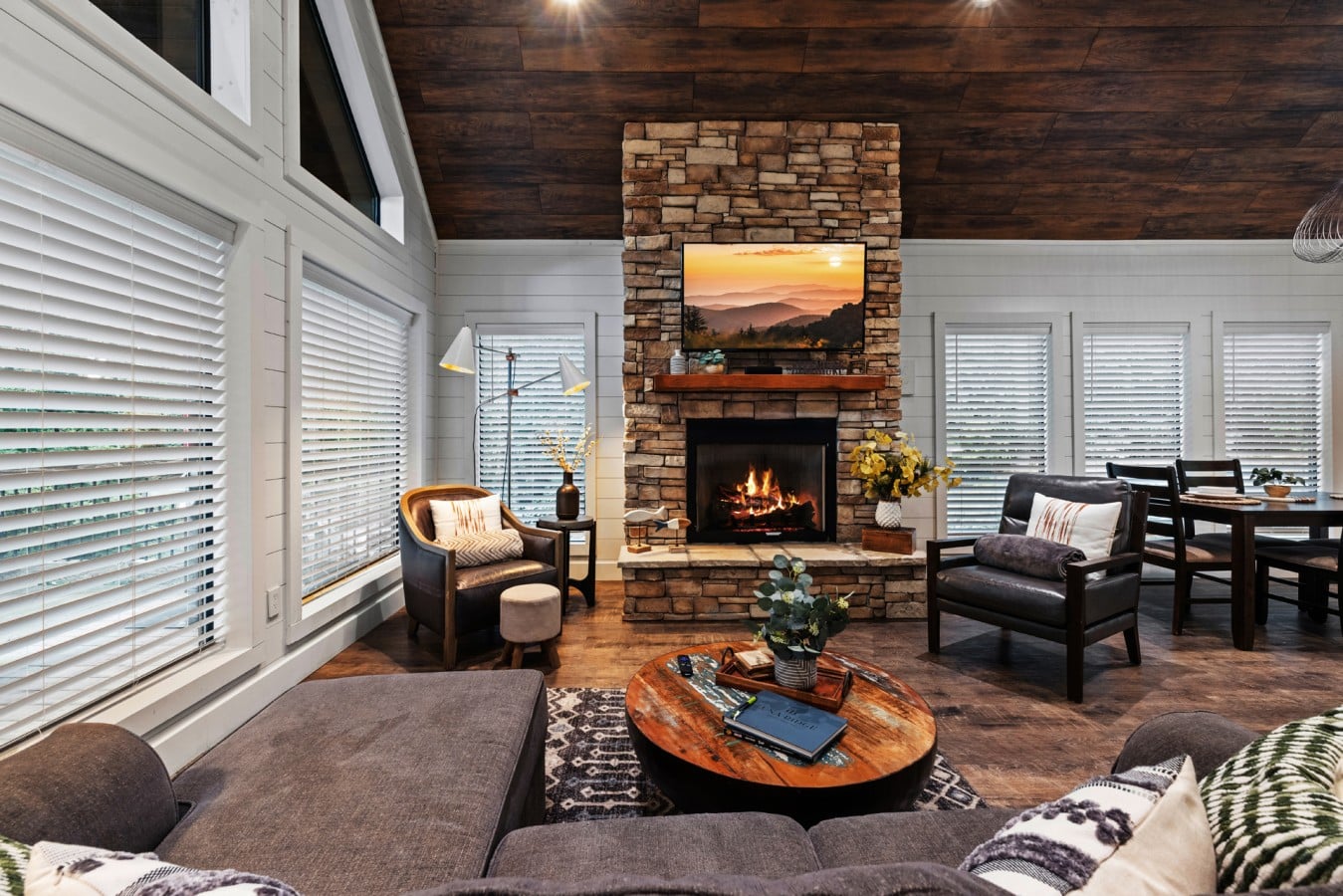 Alternate living room angle with fireplace and dining nearby.