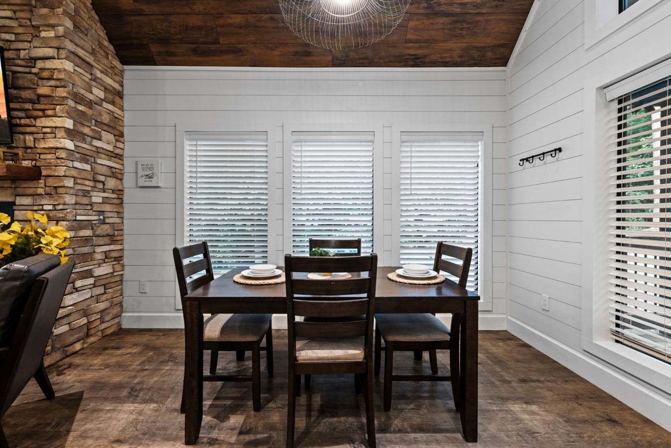 Dining nook with a wooded view and easy access to the living room.