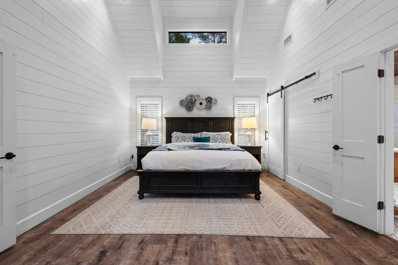 Alternate wide view of the bright king bedroom and suite layout.