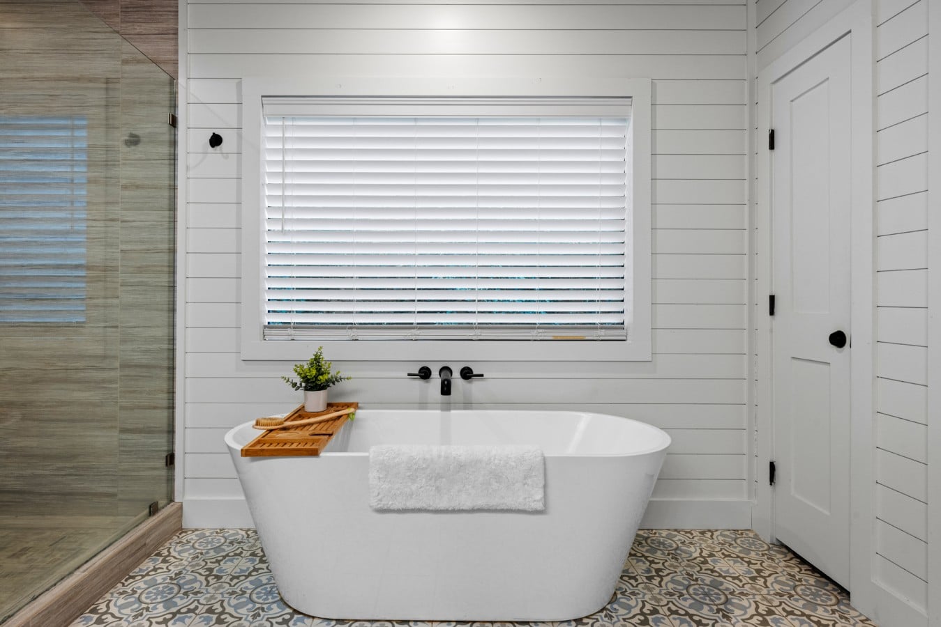 Freestanding soaking tub ready for a slow evening reset.