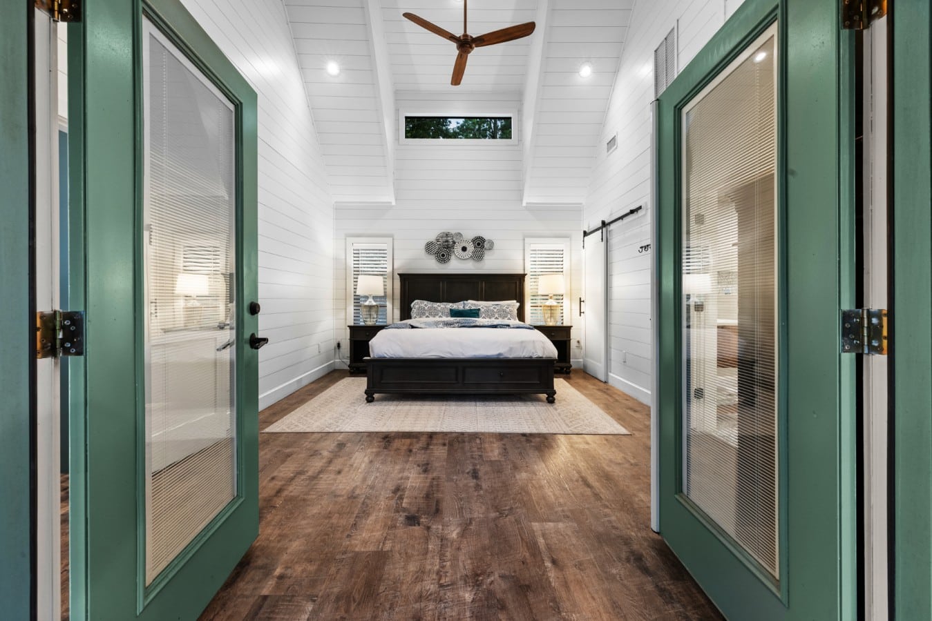 Double doors open into the king bedroom for a spacious suite feel.