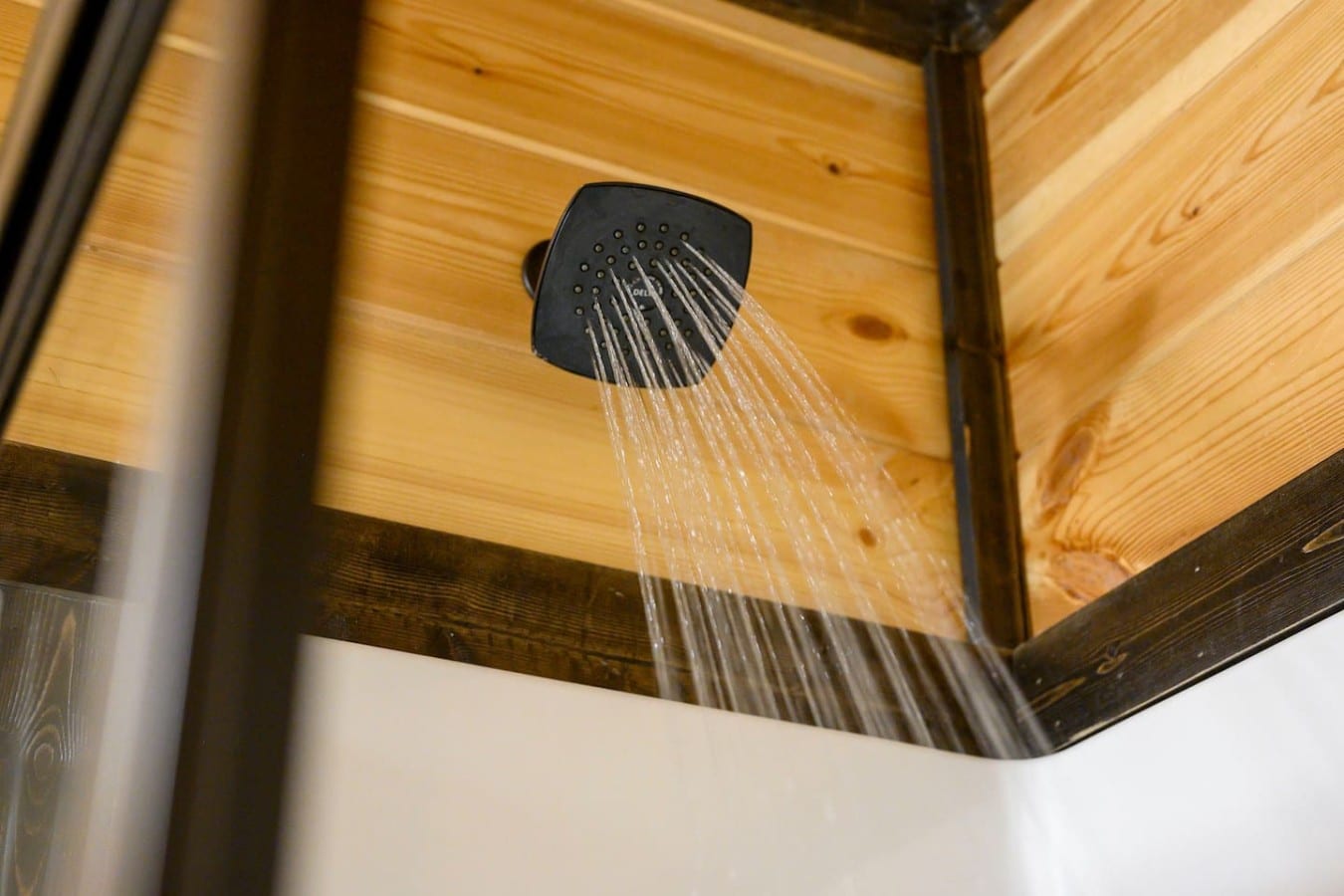 Shower head detail with modern black finish.