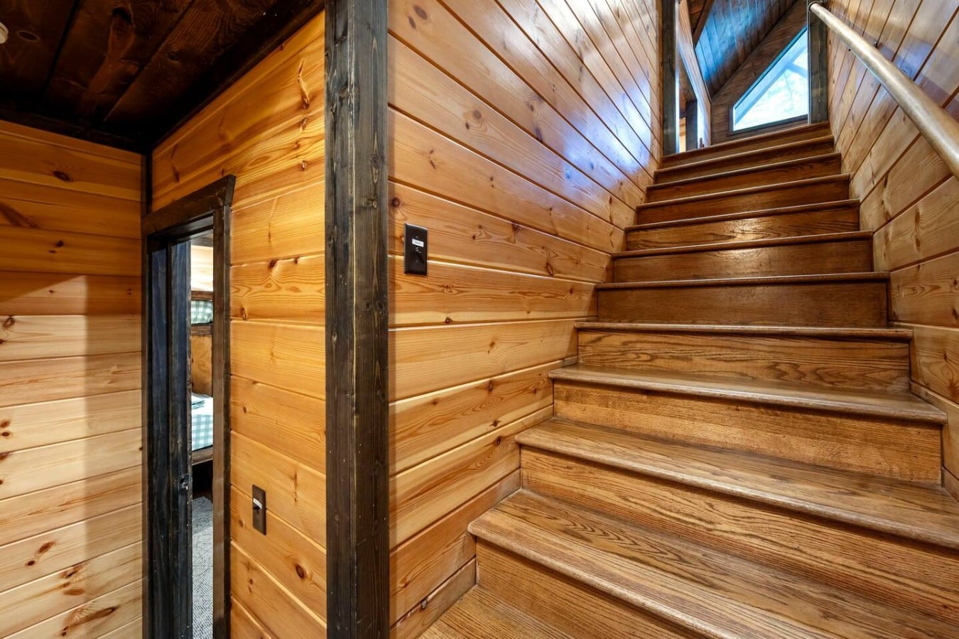 Stairway connecting the main level to the game and bunk areas.