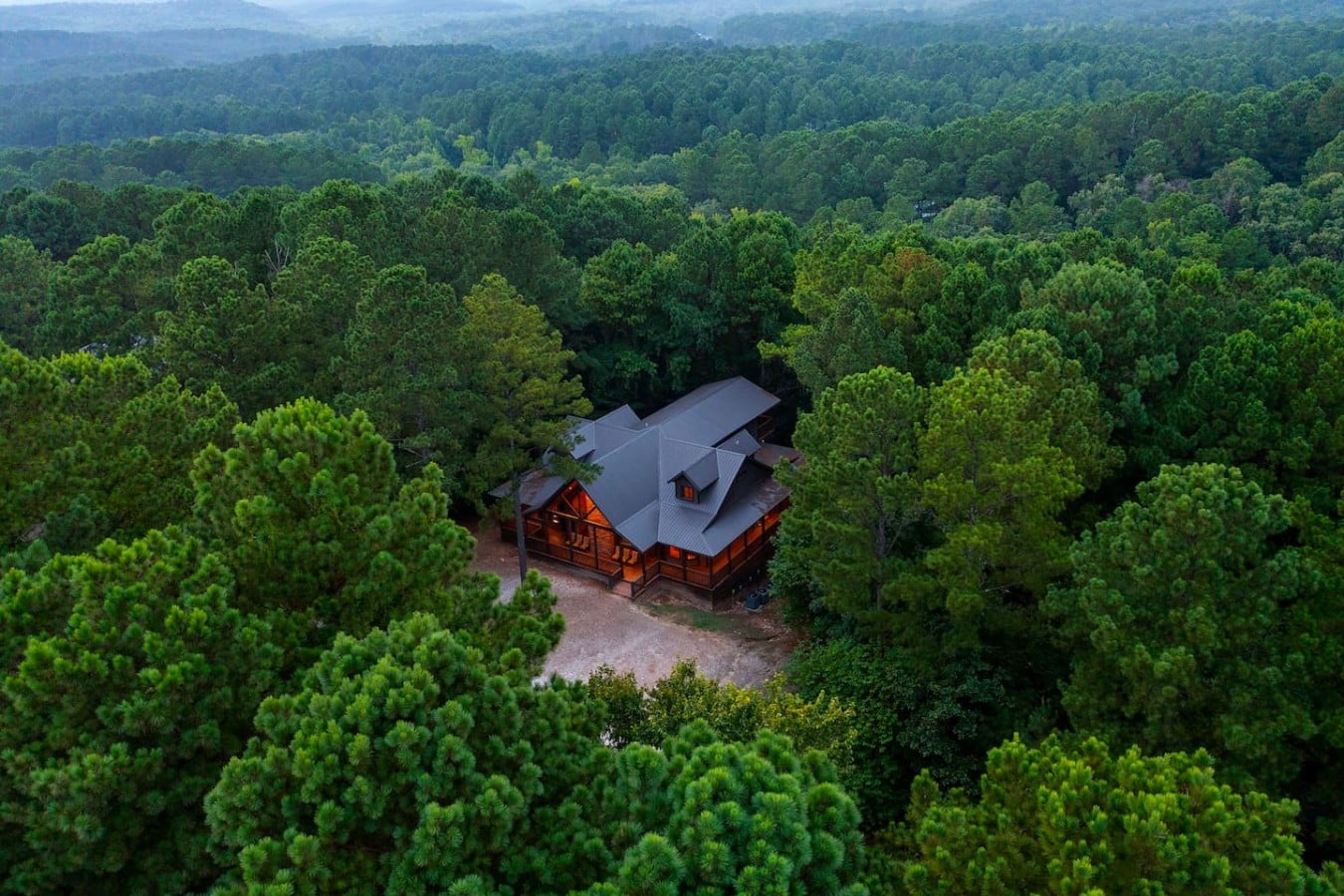 Drone view showing the cabin's private wooded setting.