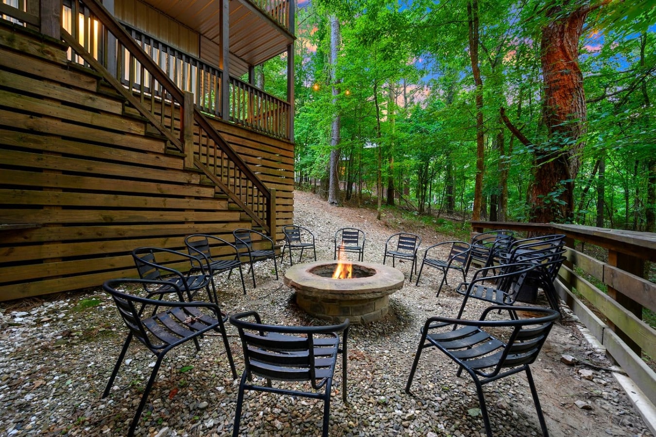 Fire pit and deck stairs tucked into the trees.