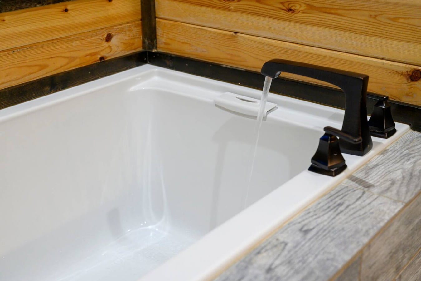 Soaking tub filler and clean tile surround.