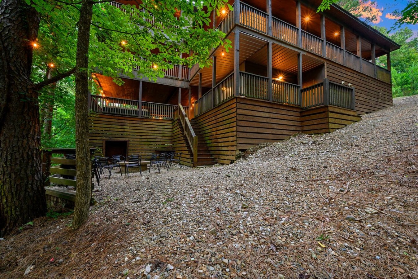 Rear exterior view showing the multi-level decks and fire pit area.