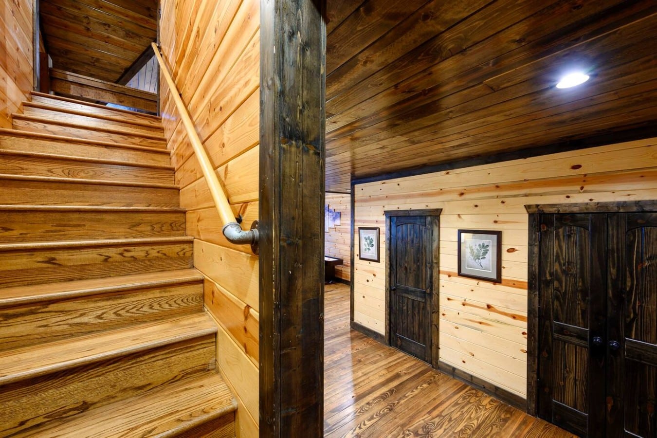 Wood staircase leading to the upper sleeping spaces.
