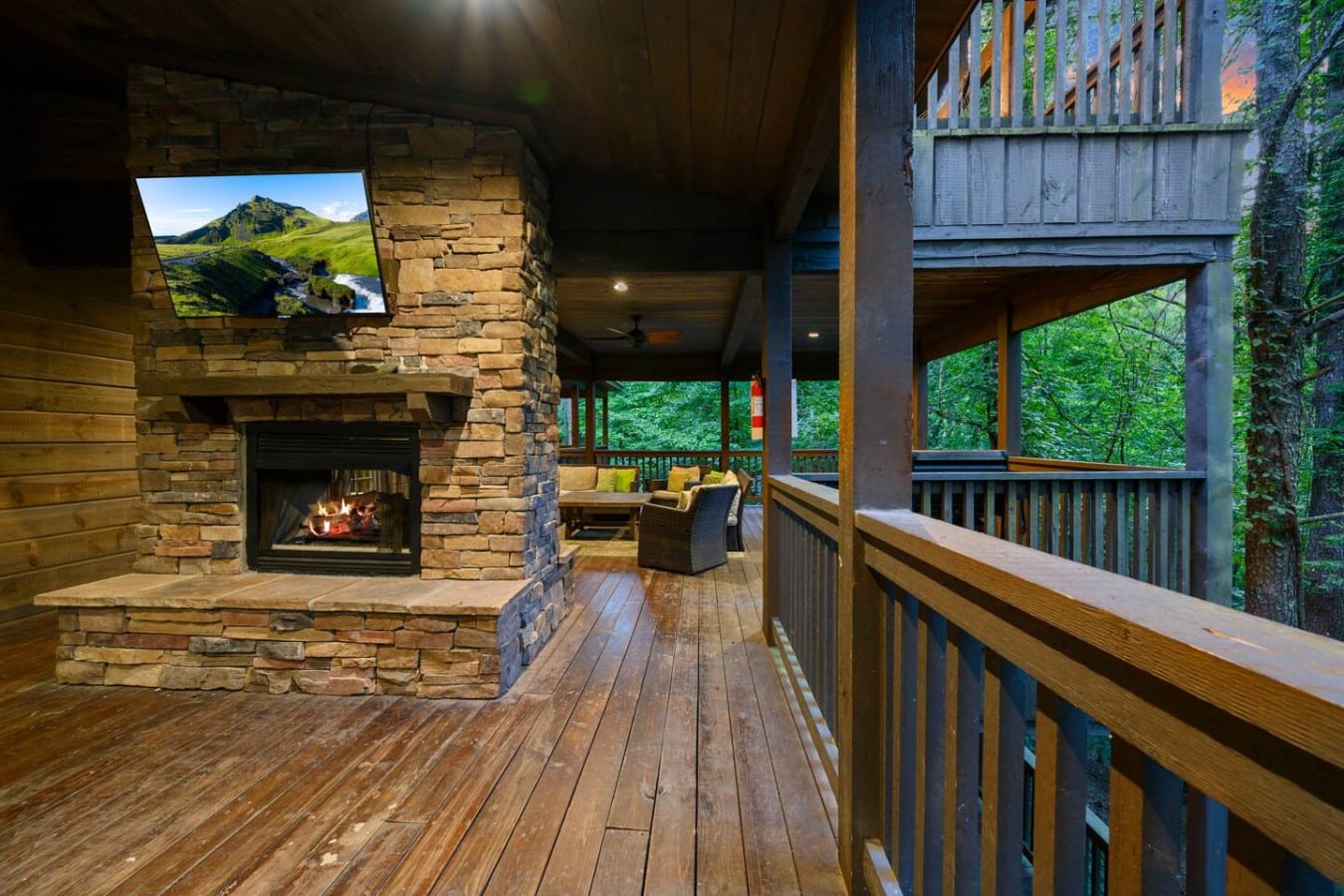 Outdoor fireplace and TV on the covered deck.
