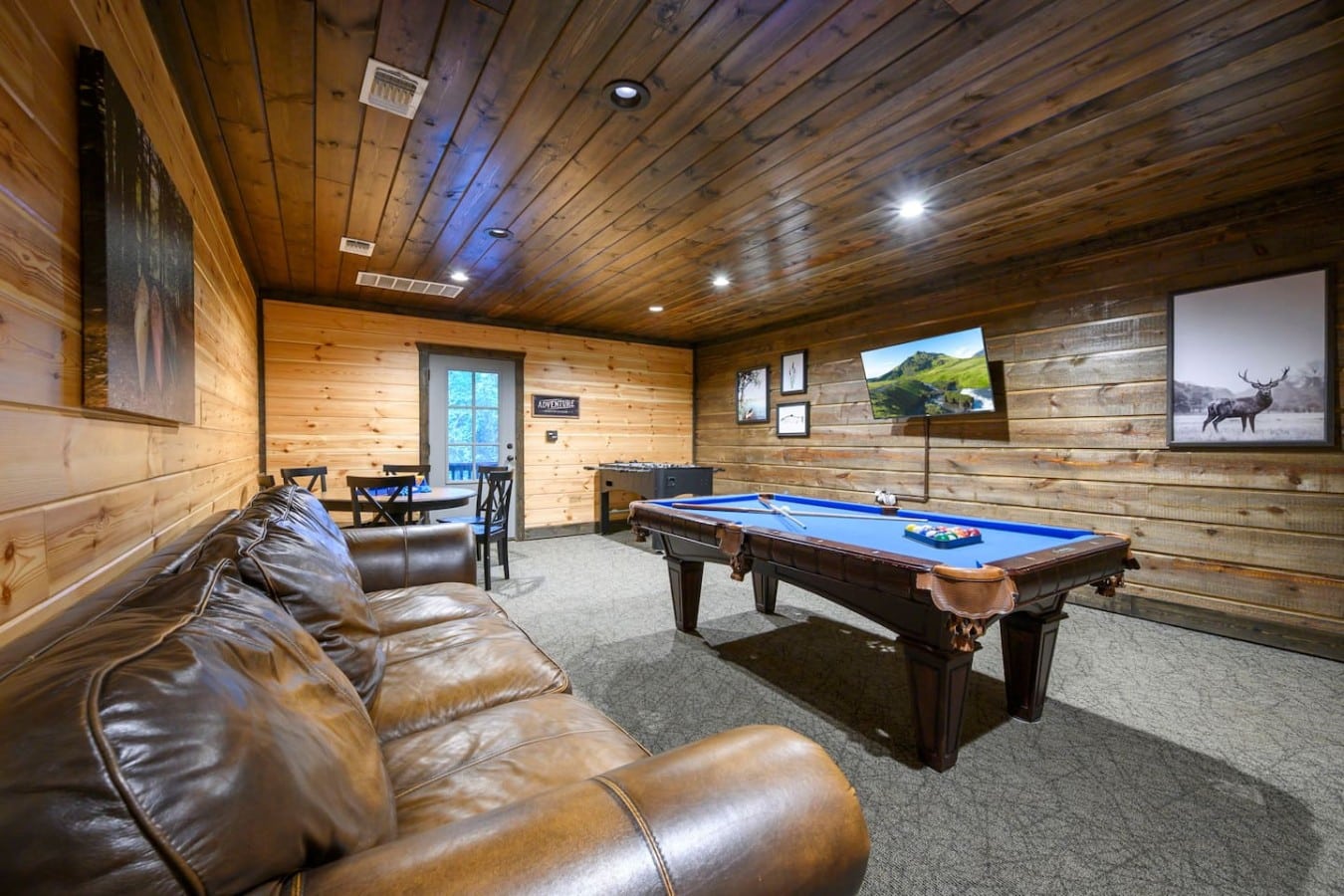 Game room lounge with pool table and comfortable seating.