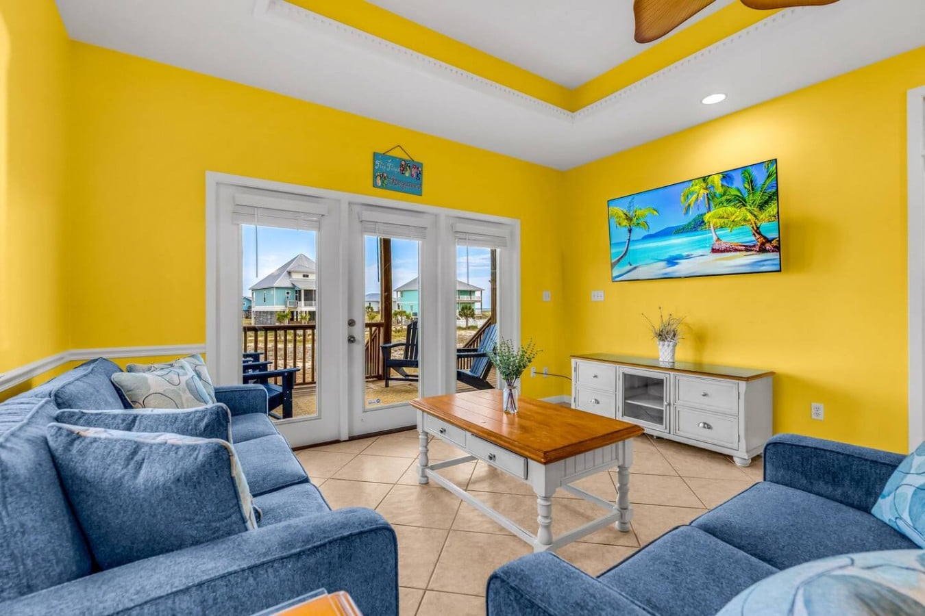 Kick back on blue sofas with the beach neighborhood just beyond the doors.