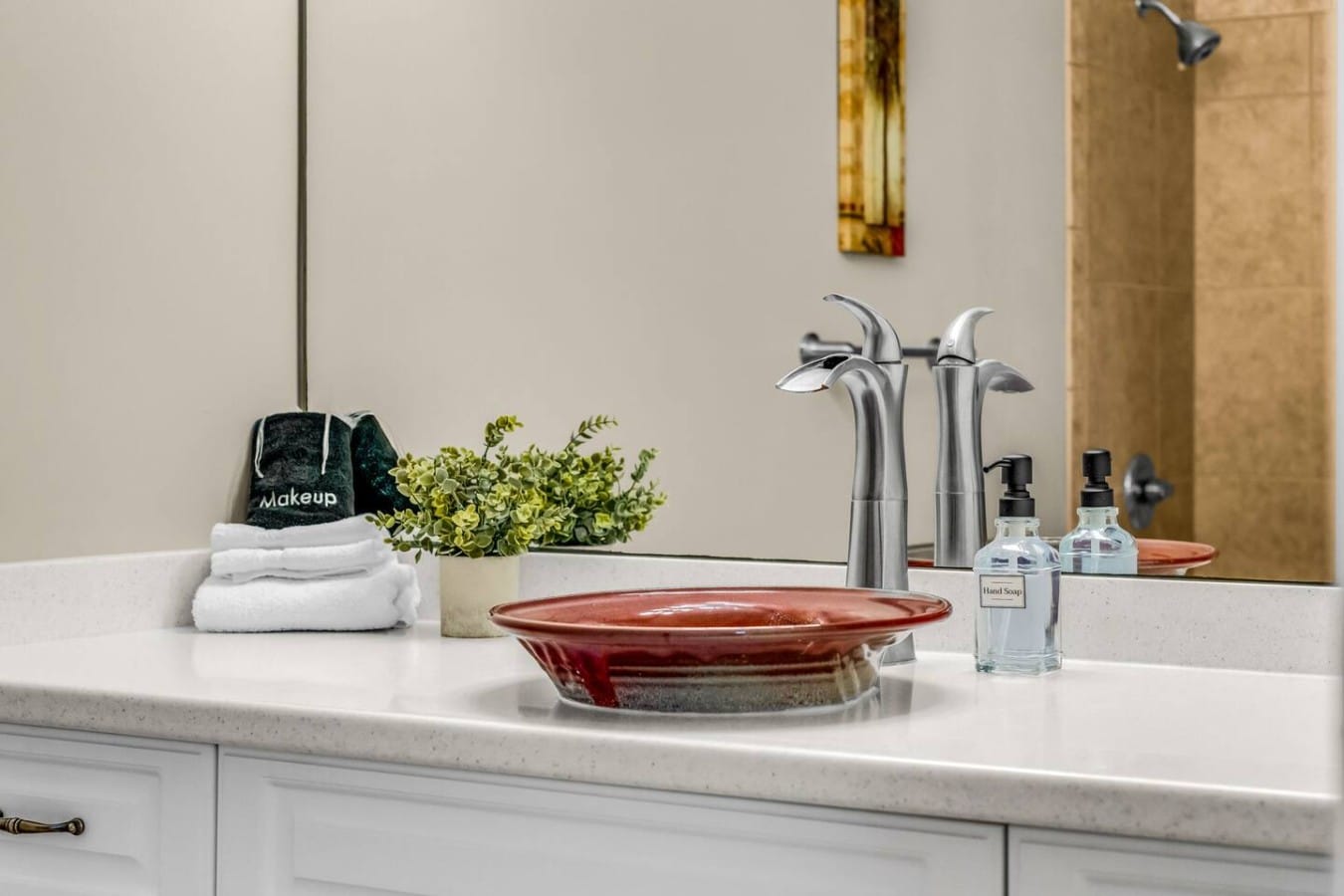 Sculptural faucets and fresh greenery give this vanity a chic, resort-worthy elegance.