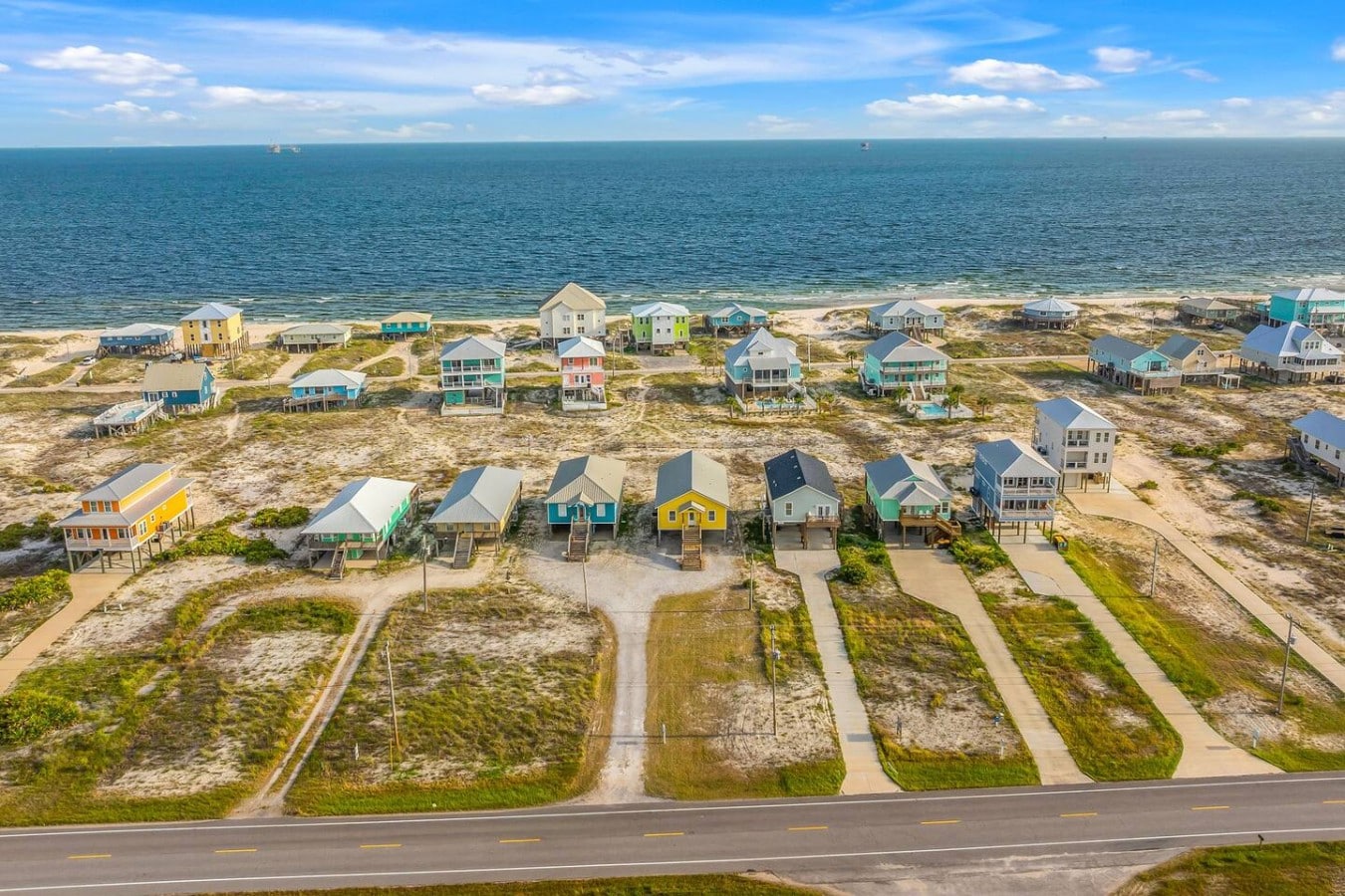 Gulf water glimmers at the end of the street from this prime coastal address.