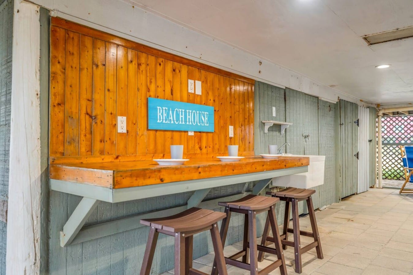 Mix drinks and make memories at your own private beach bar beneath the house.