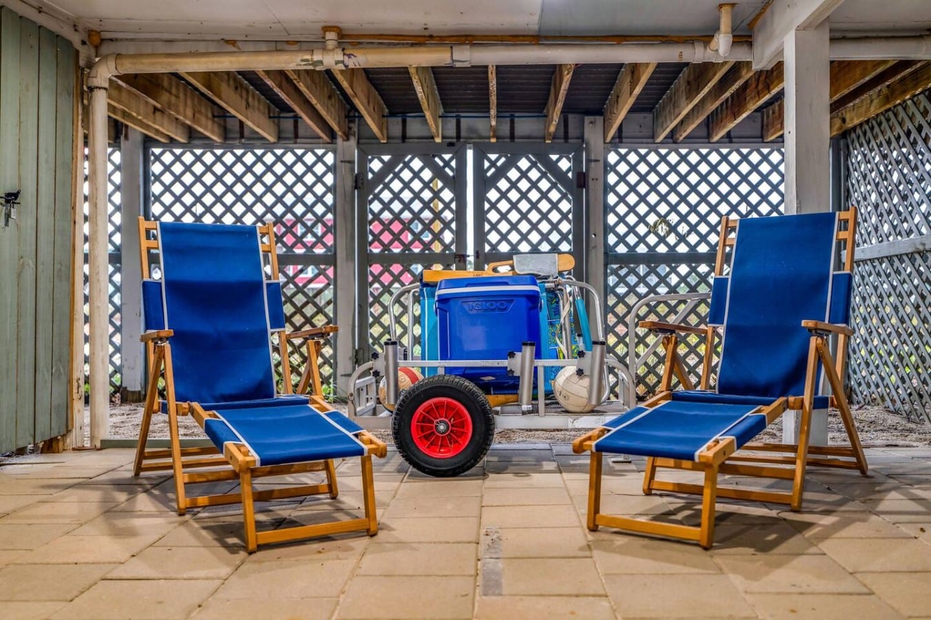 Everything you need for a perfect beach day — loungers, cooler, and cart — already waiting.