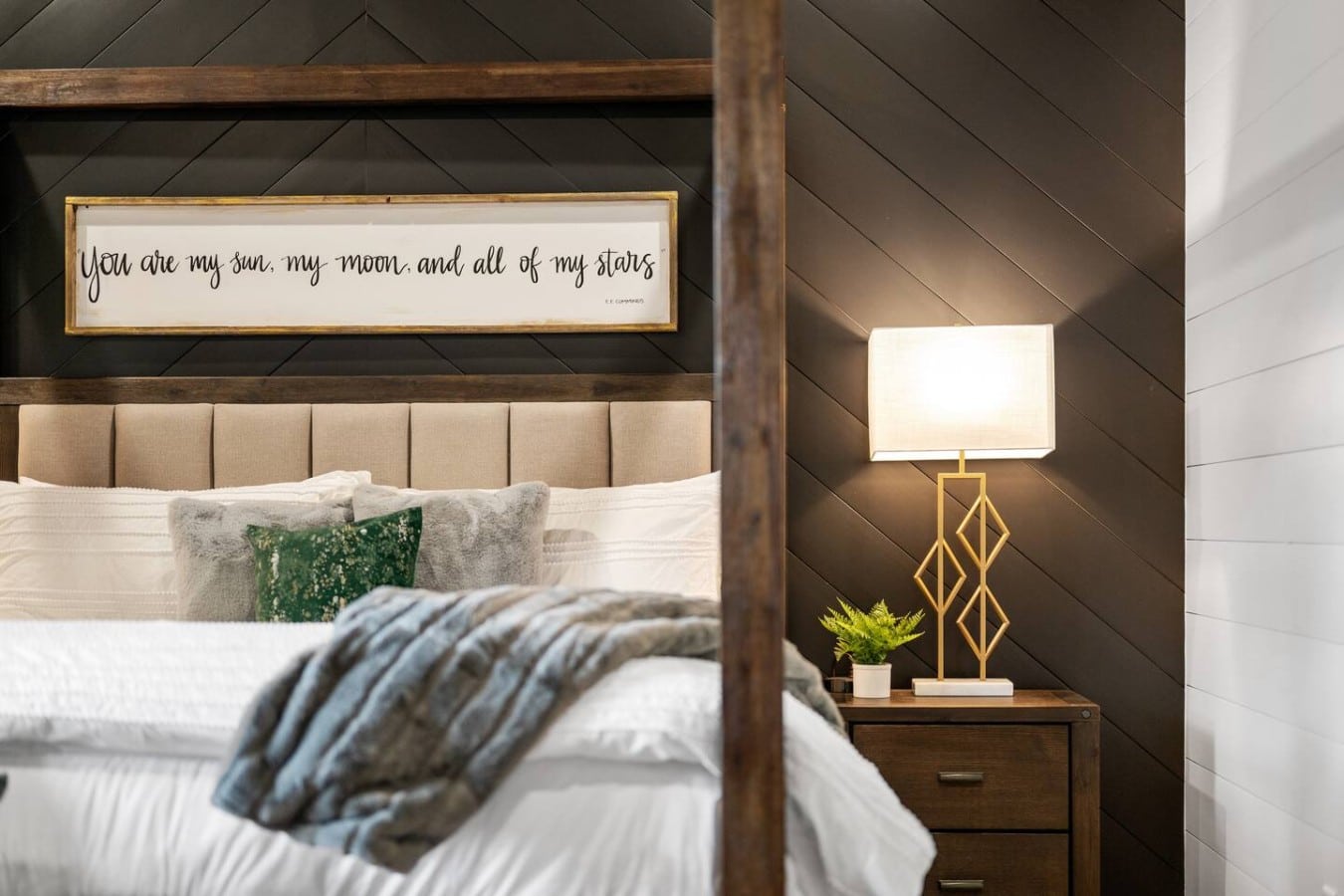 Bold chevron walls and a glowing gold lamp create a nightstand moment you'll want to photograph.