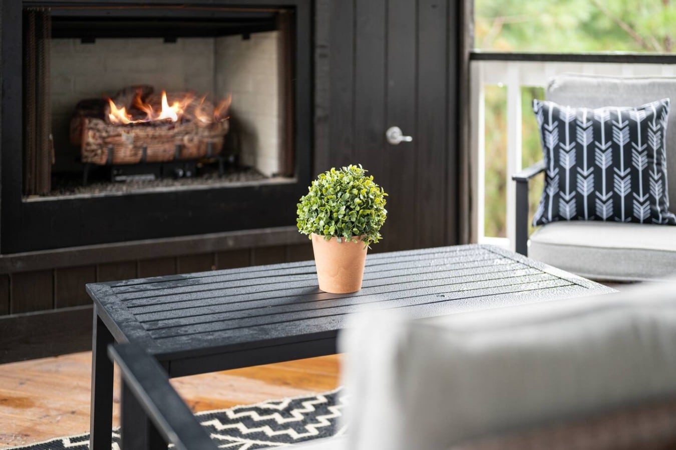A roaring fireplace and stylish seating make this outdoor space a cozy year-round escape.