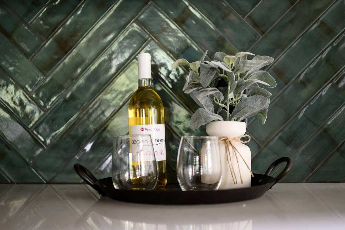 Pour a glass of wine and let the emerald tile backdrop inspire your evening in the kitchen.