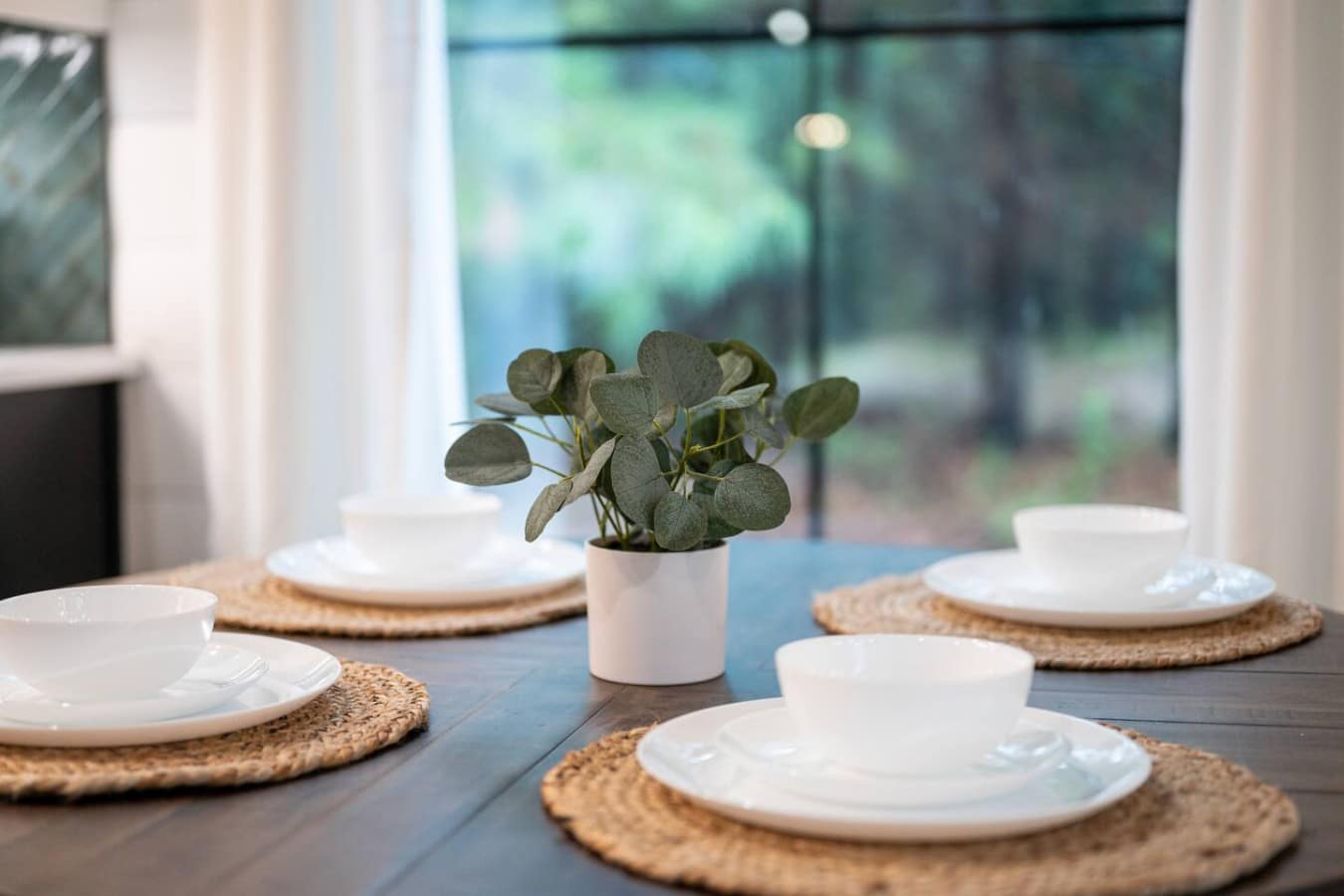 Dine surrounded by greenery and natural light at a table that's set and waiting just for you.