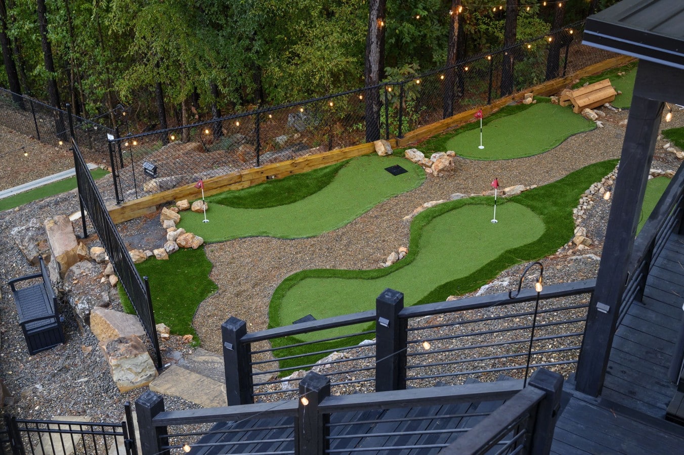 An aerial-view putting green lit by string lights at dusk is a golfer's dream come true.