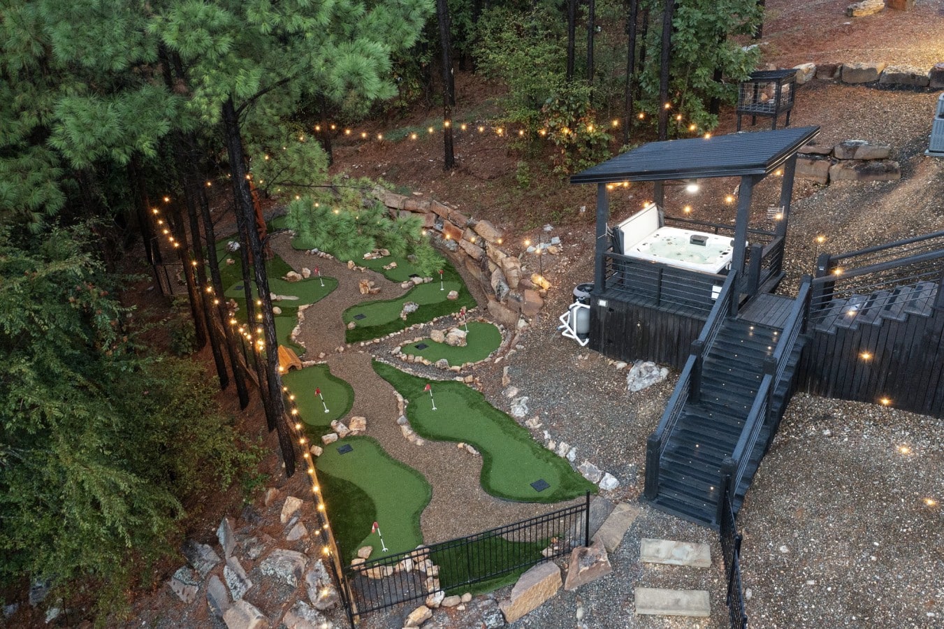 Mini golf, a hot tub pavilion, and string lights through the pines — a backyard unlike any other.