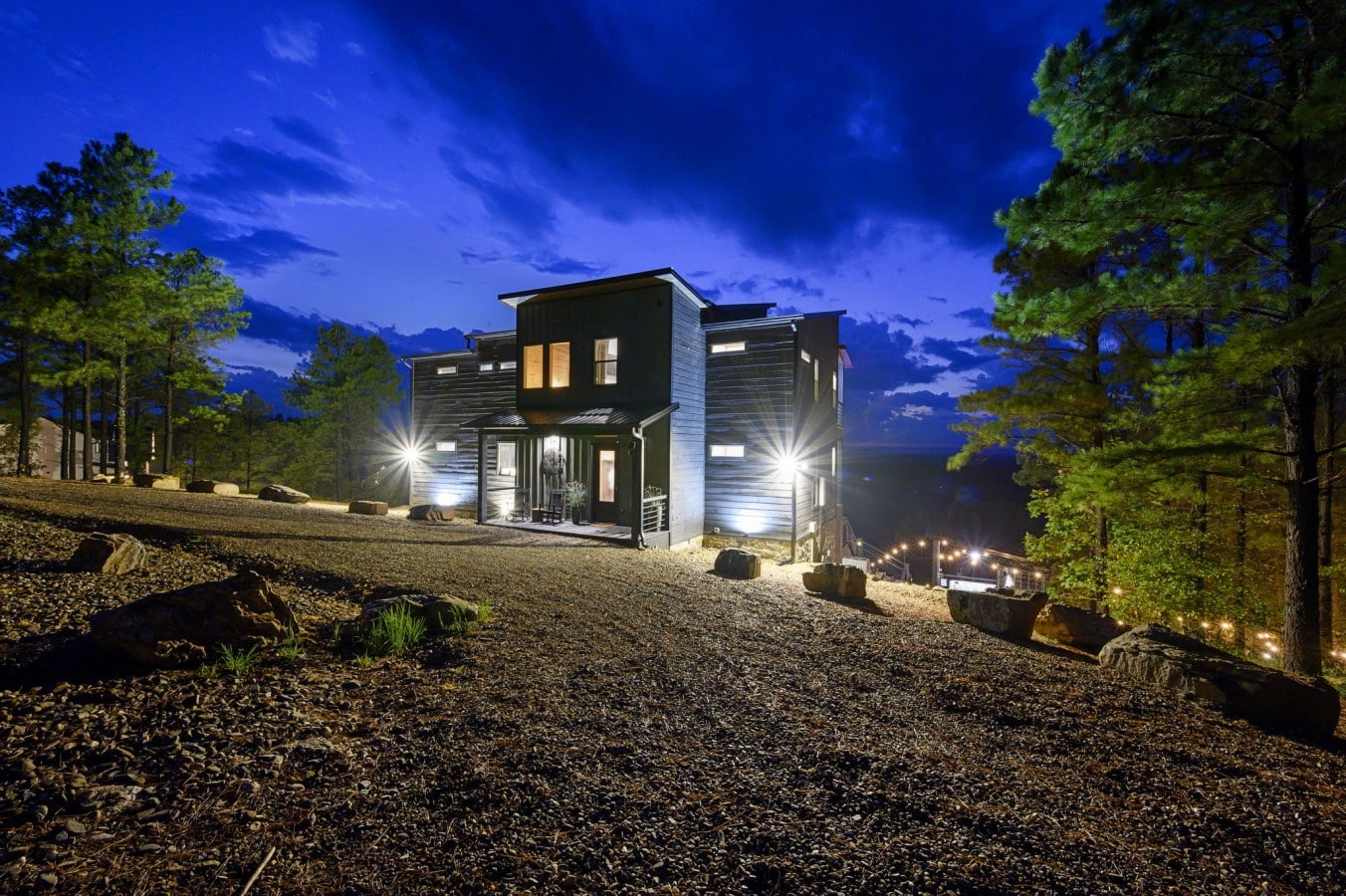 String lights and uplighting make this hillside cabin magical long after dark.