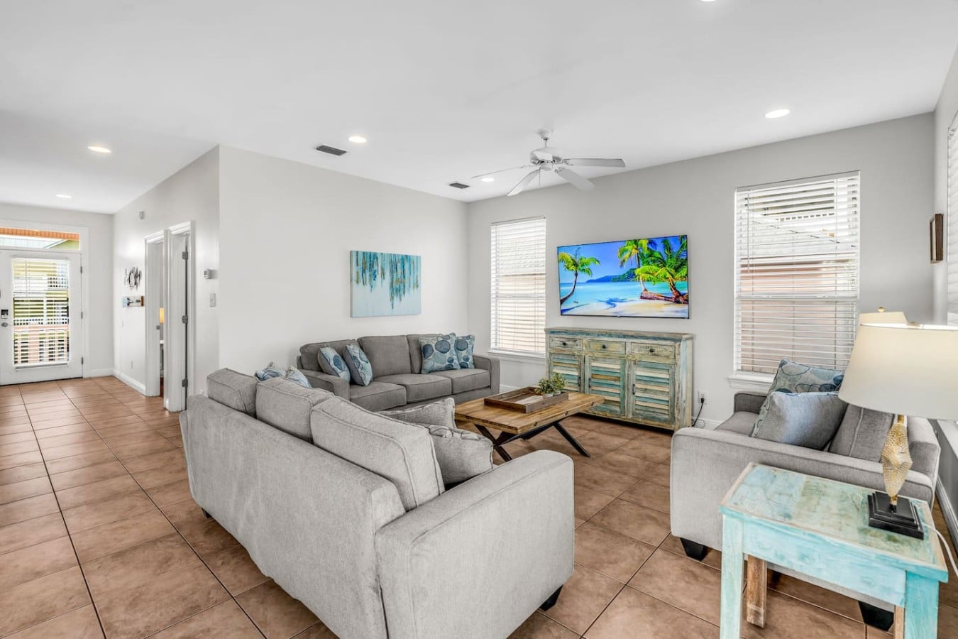 Coastal charm fills every corner of this bright, welcoming living room made for gathering.