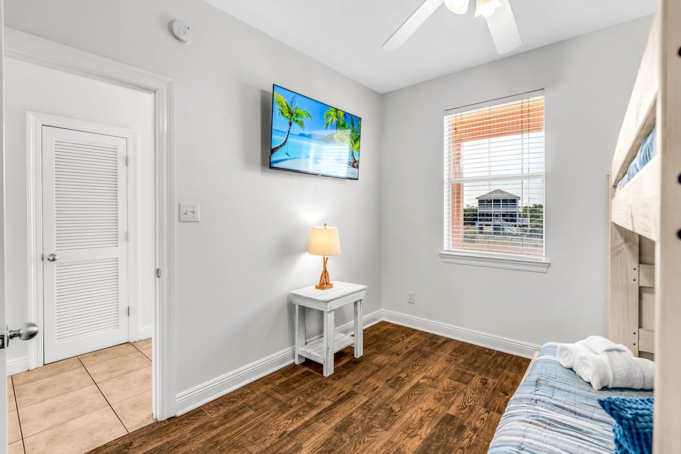 Bunk beds, a ceiling fan, and a TV make this the room every kid fights over.