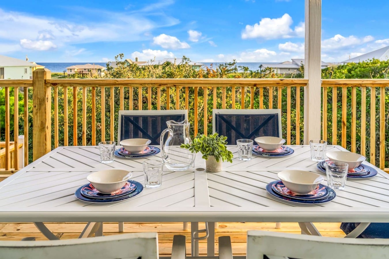 Dine al fresco for six with the Gulf glimmering just beyond the railing.