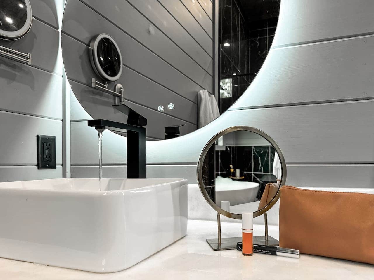 A backlit mirror and matte black fixtures add a boutique-hotel feel to your morning routine.