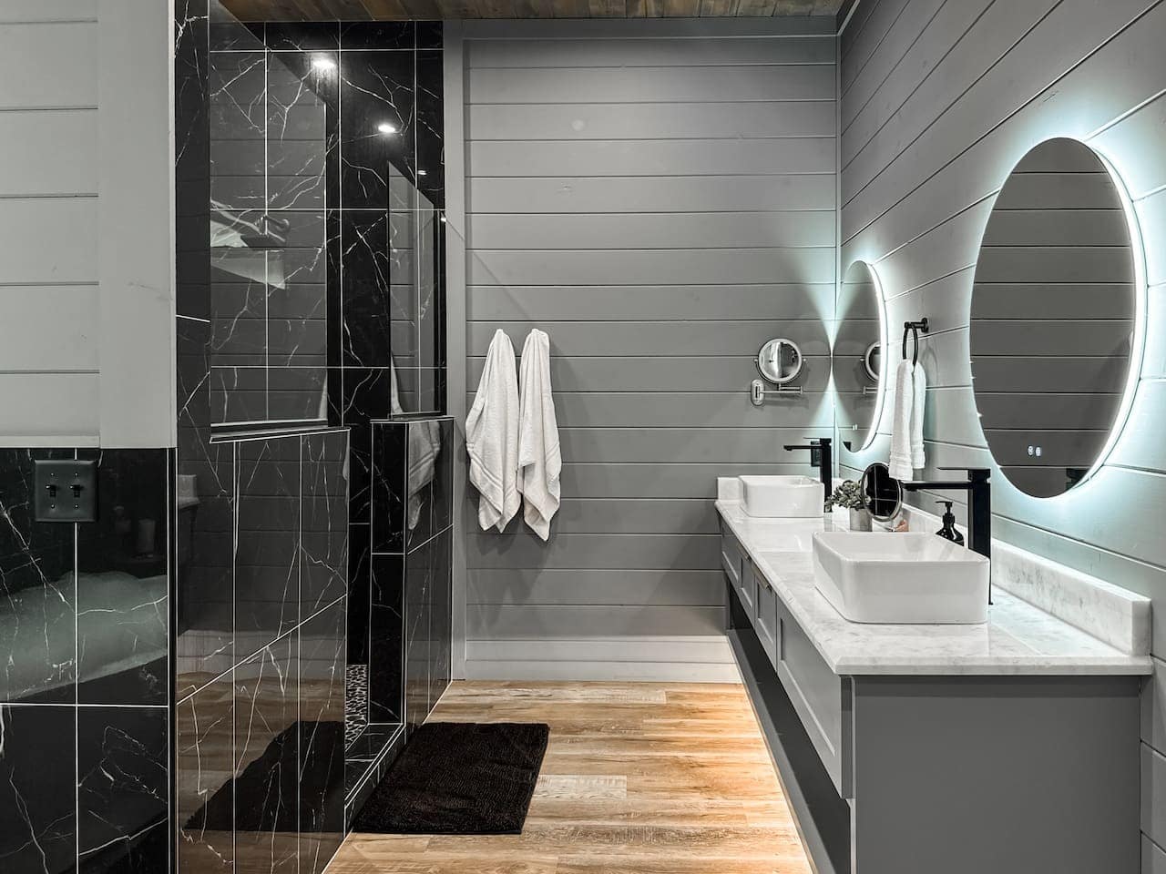 A double vanity and marble rain shower turn every morning into a spa ritual.