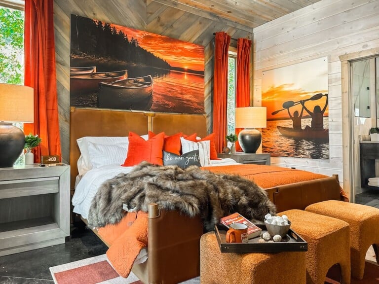 Dramatic canvas prints and sunset tones fill this bedroom with warmth and personality.