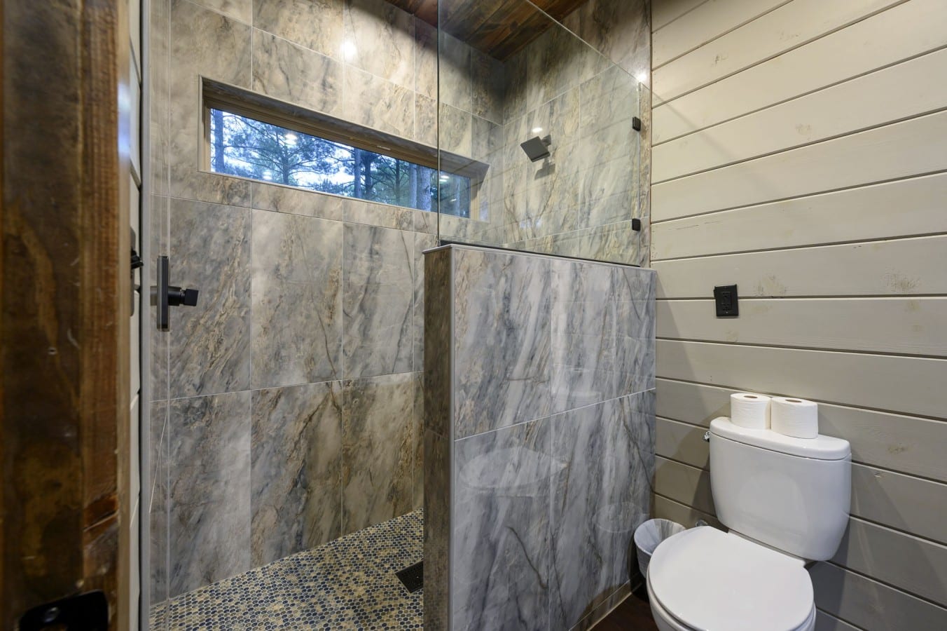 Rinse off under a rain showerhead with a pine forest view to match.