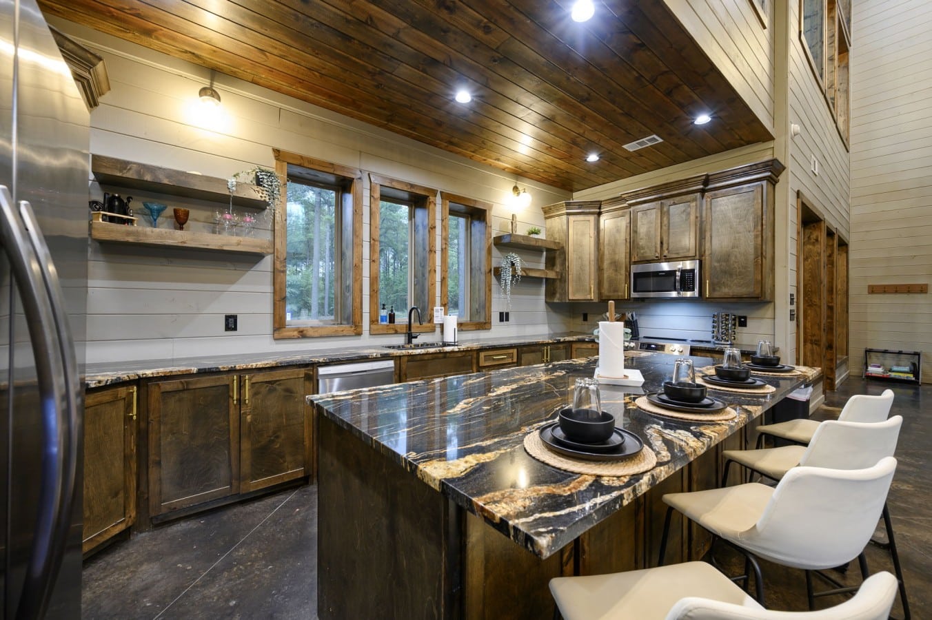 Gather at the island for appetizers before moving to the grand dining table.