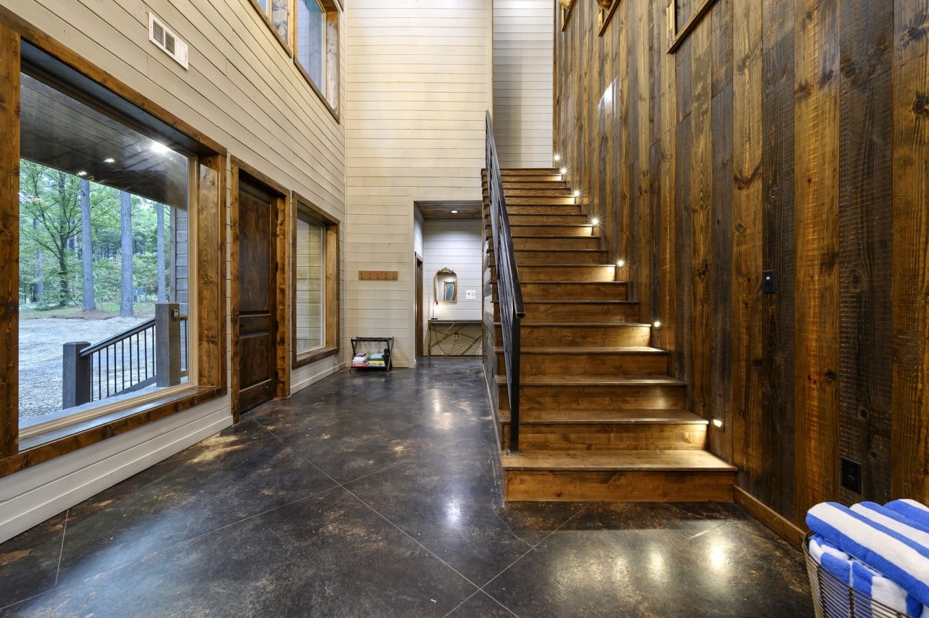 Lit stairs and reclaimed wood walls make every floor feel like a retreat.